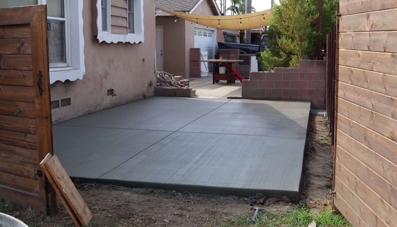 Smooth concrete patio freshly poured in a backyard in Tacoma, WA
